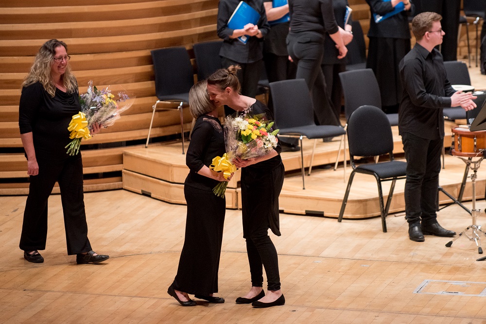 Soloist receiving applause and a bouguet at the end of the concert.